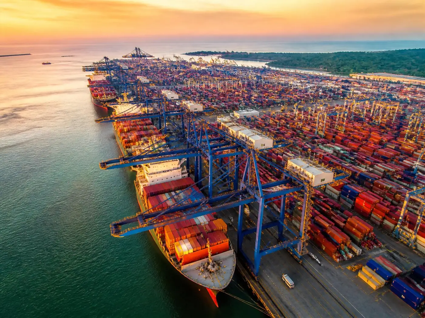 Between the cranes and the container stacks.